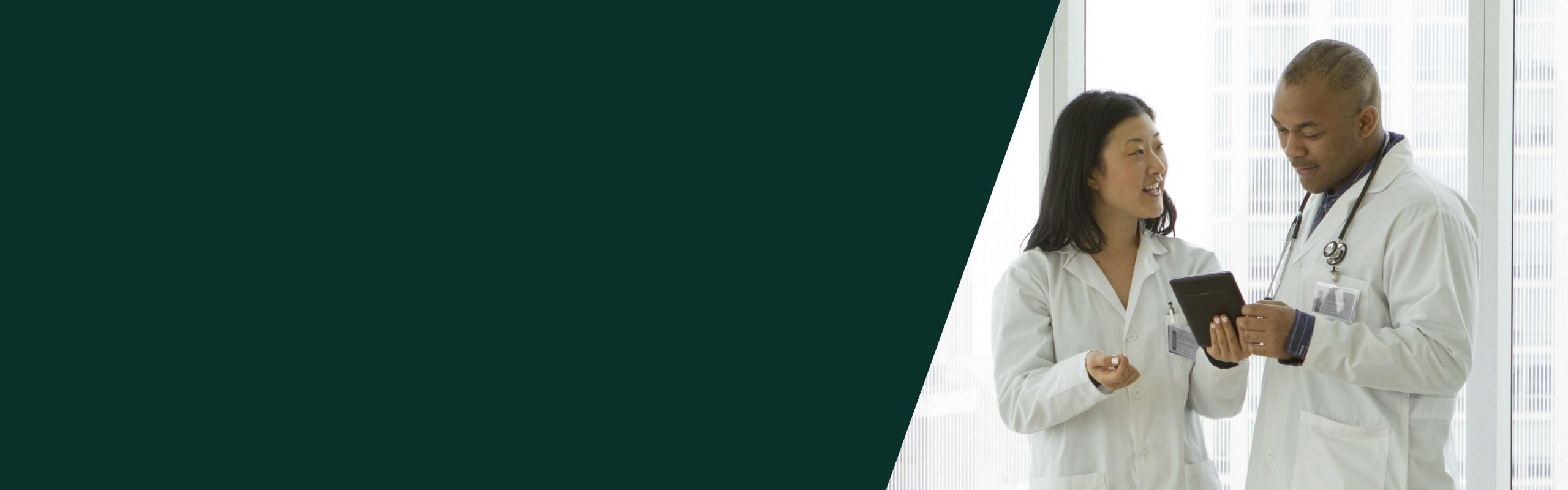 male and female vets discussing a chart